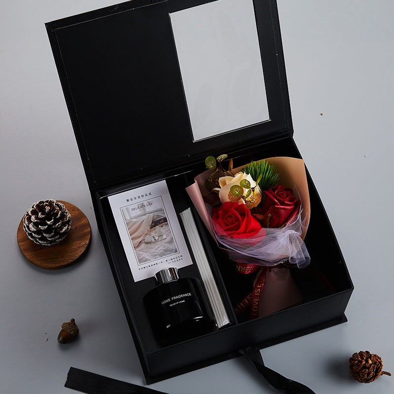 Mini red and white rose bouquet and home fragrance diffuser in a black gift box